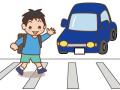 手をあげて横断歩道を渡る小学生