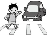手をあげて横断歩道を渡る小学生